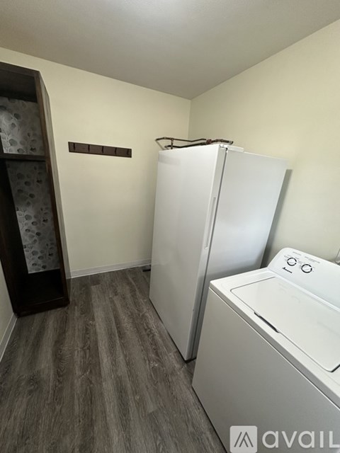 A small laundry room with a washer and dryer.