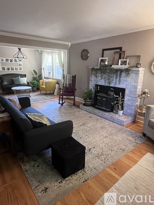 A living room with a fireplace and a chair.
