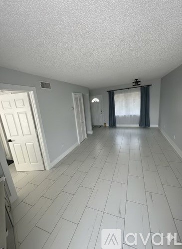 A room with white tiled floors and white walls.