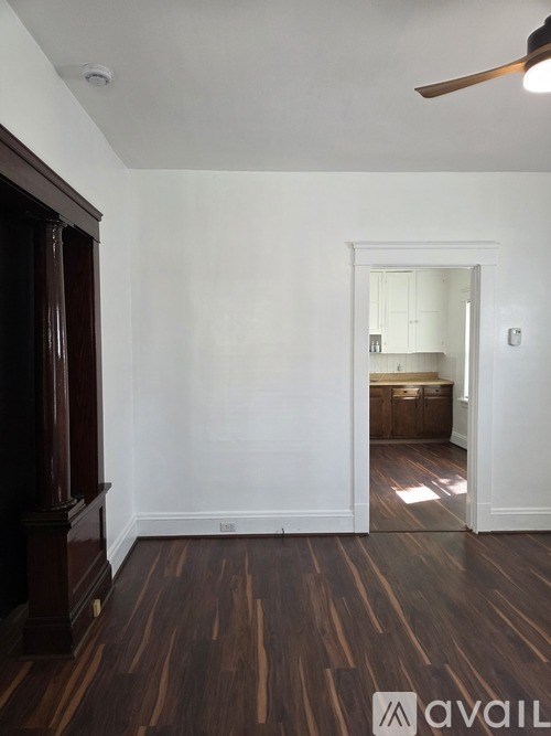 A room with wooden floors and white walls.