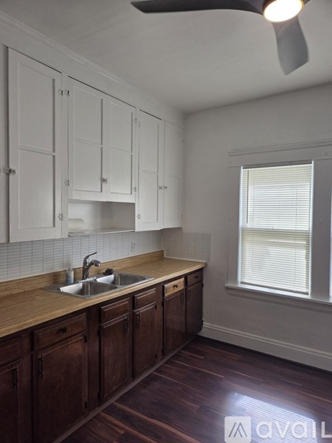 A kitchen with wooden cabinets and a sink.