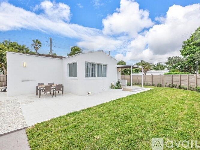 A white house with a patio and a table.