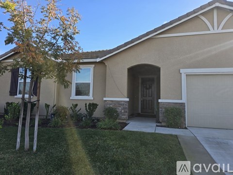 A house with a brown roof and a white garage door.
