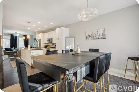 A modern dining room with a large table and chairs.