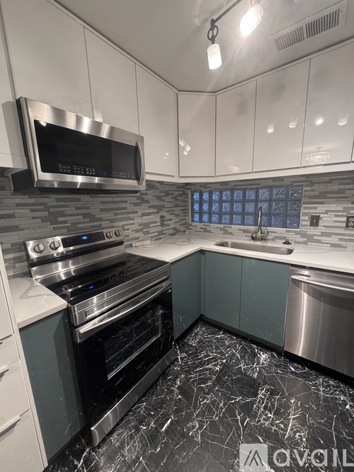 A modern kitchen with a stainless steel oven and sink.