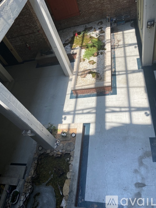 A small garden area is located under a bridge.