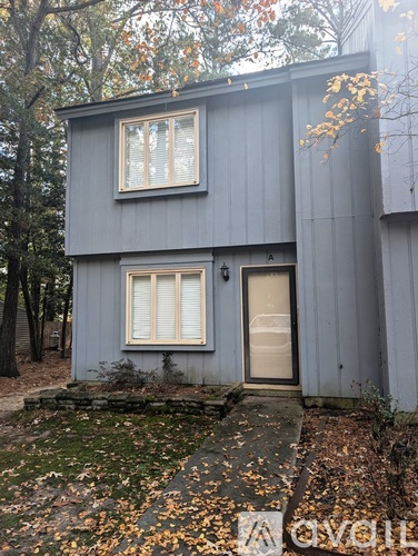 A grey house with a white door and windows.
