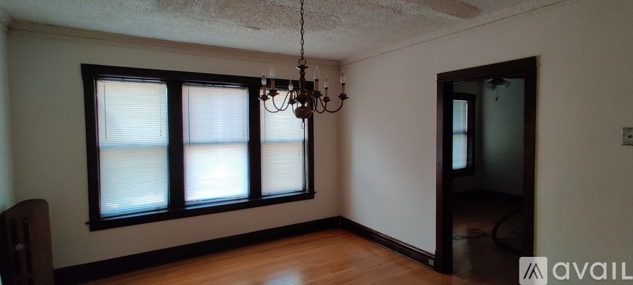 A room with a window and a chandelier.