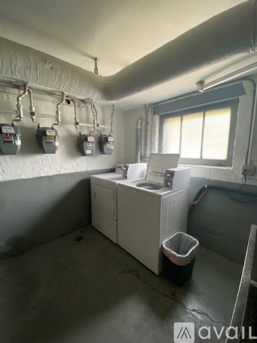 A bathroom with a white sink and a window.