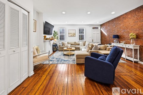 A living room with a blue chair and a white table.