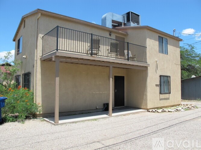 A two-story house with a balcony and a balcony railing.