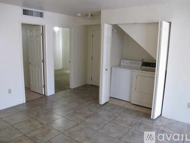 A room with a washer and dryer in it.