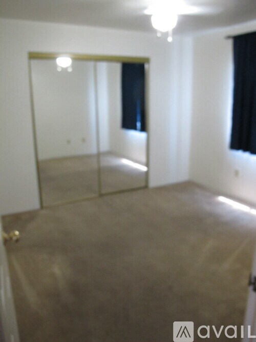 A room with a mirror and a door.