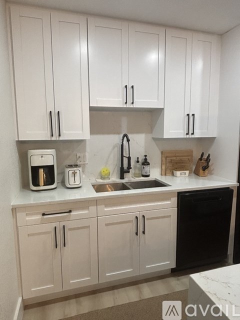 A hallway with a white door and a mirror on the wall.