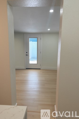 A room with a desk and a chair in it.