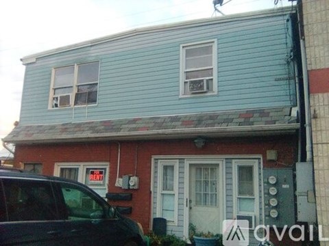 A blue house with a red one next to it.