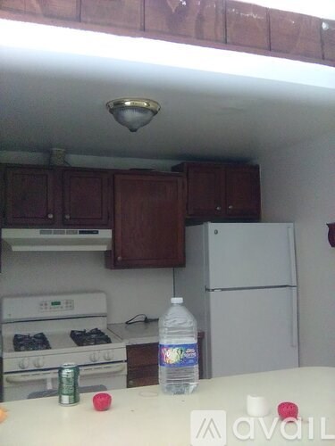 A kitchen with a white stove and a white refrigerator.