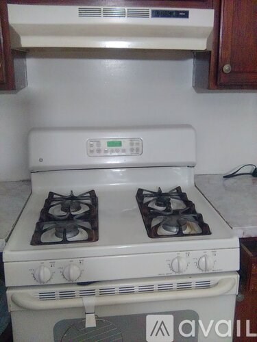 A white gas stove with two burners and a digital display.