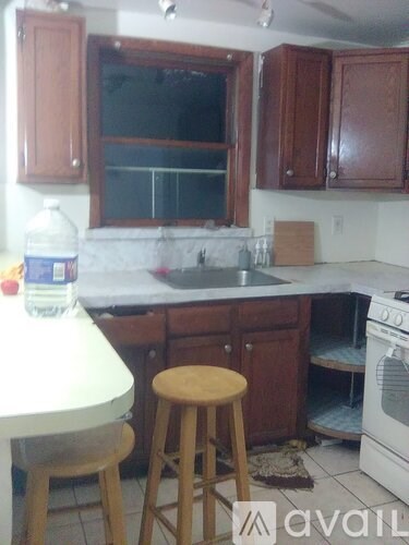 A kitchen with wooden cabinets and a white oven.