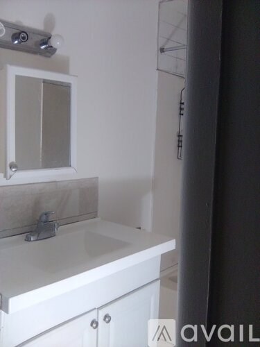 A bathroom with a sink and mirror.