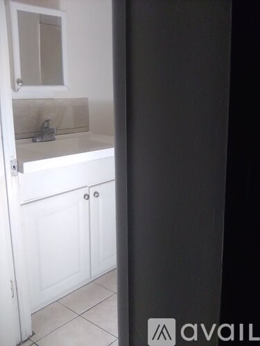 A bathroom with a sink and a mirror.