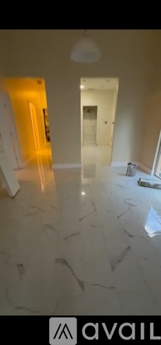 A room with a white floor and a white ceiling with a light fixture.