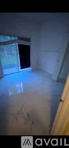 A room with a large window and a door.