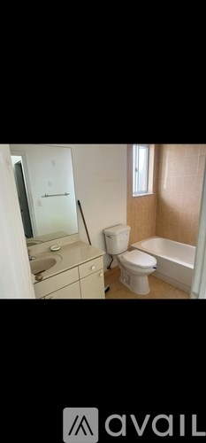 A bathroom with a toilet, sink, and bathtub.