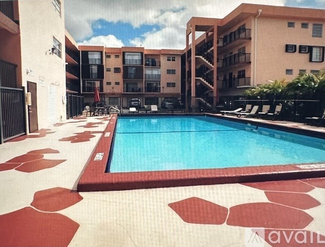 A large pool surrounded by a red and white tiled patio.