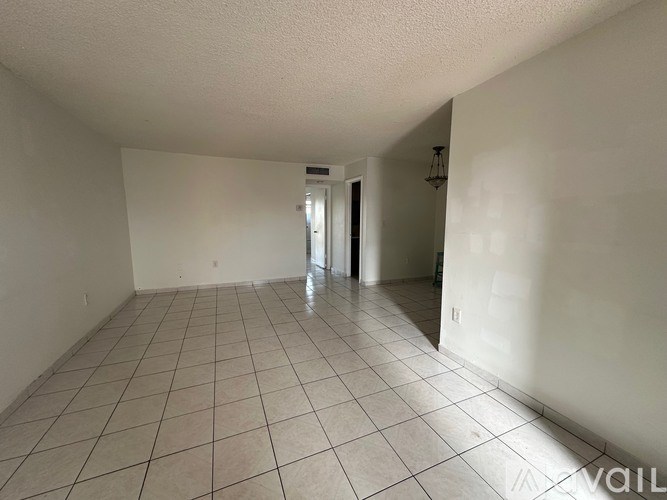 A room with white walls and a tiled floor.