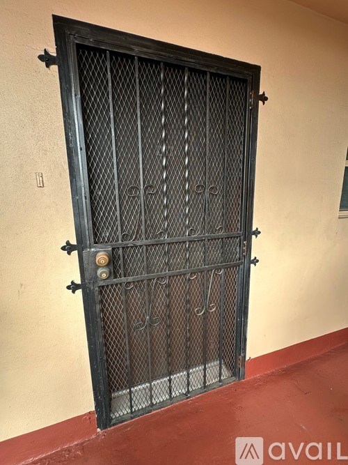 A black metal gate with a lock on it.