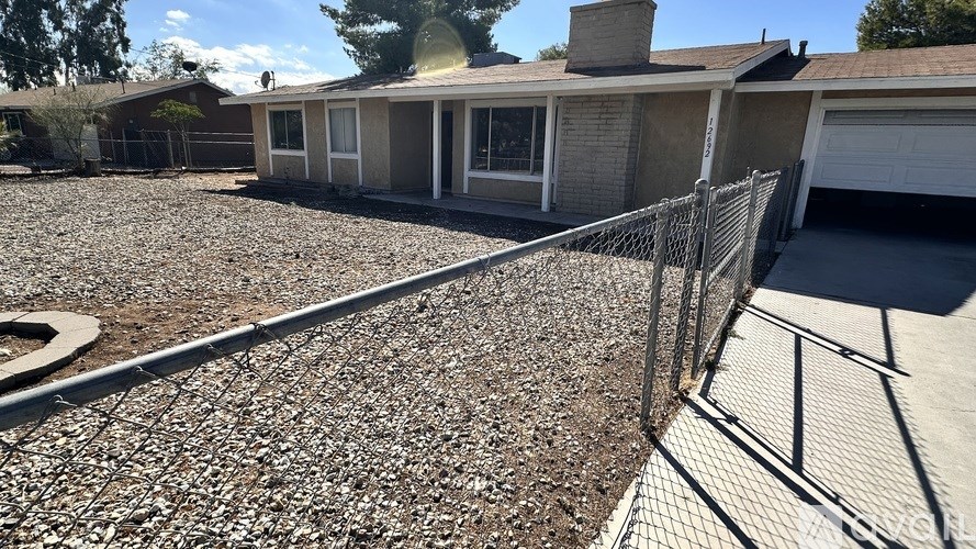 A house with a grey roof and a grey garage door.