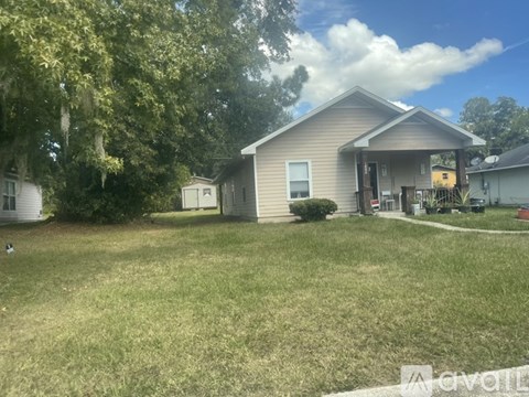 A house with a grey roof and a white garage door.