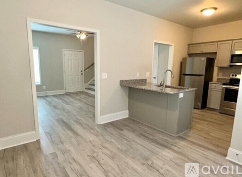 A kitchen with a white countertop and a sink.
