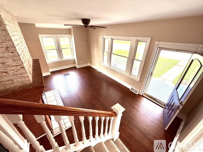 A sunny day in a house with a staircase leading to the second floor.