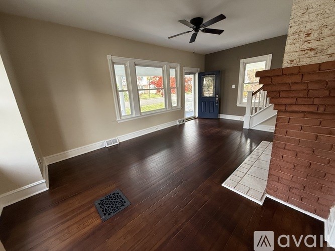 A room with a wooden floor and a ceiling fan.