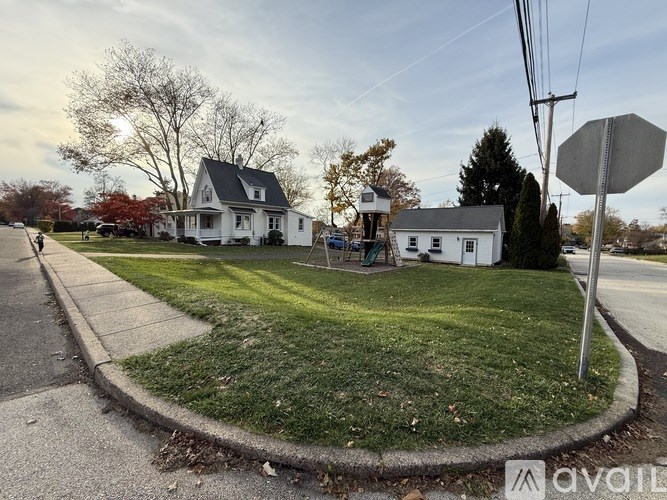 A stop sign is on a pole at the side of a road.