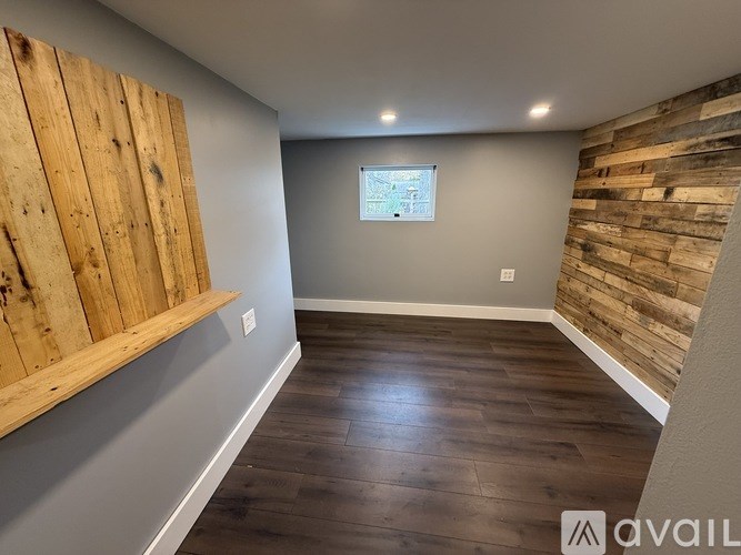 A room with wooden floors and a window.