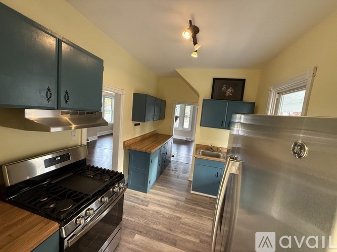 A kitchen with a stove top oven and a refrigerator.