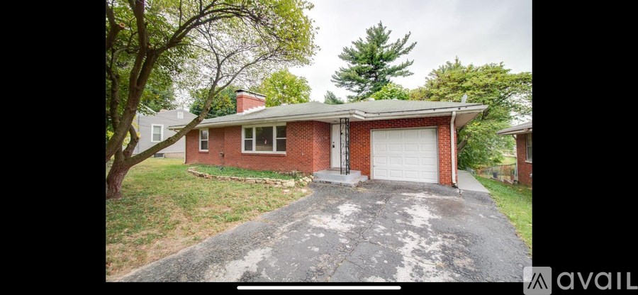 A red brick house with a white garage door.