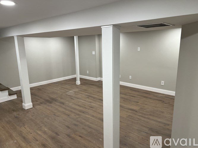 A room with wooden floors and white walls.