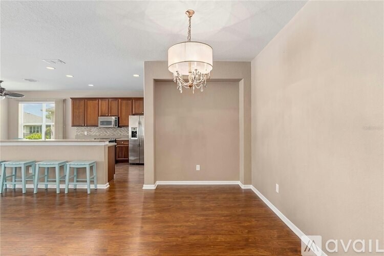 A large empty room with a chandelier hanging from the ceiling.