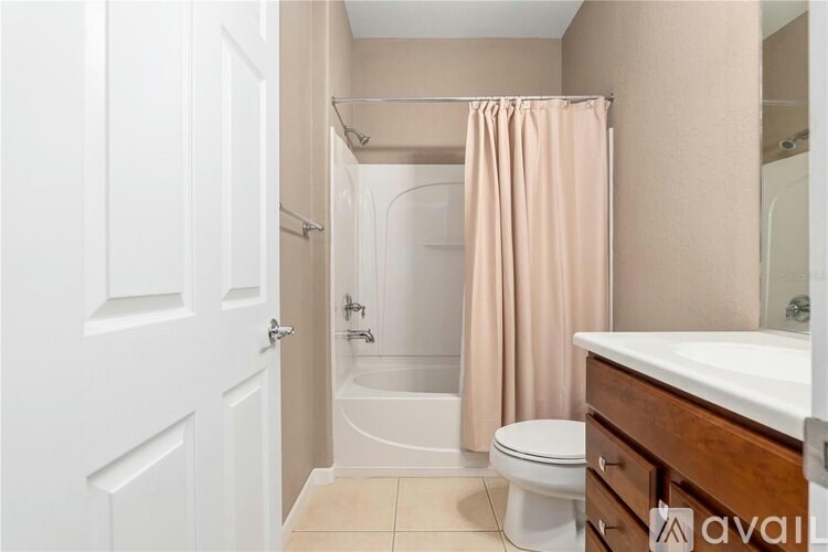 A bathroom with a toilet, sink, and shower.