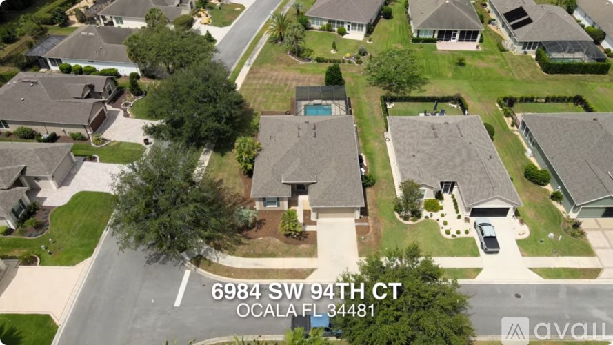 A bird's eye view of a residential neighborhood with houses and a street.