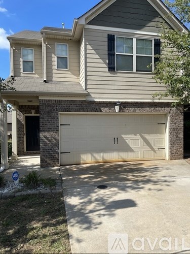 A two-story house with a garage door that has the number 11 on it.