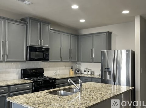 A kitchen with granite countertops and stainless steel appliances.