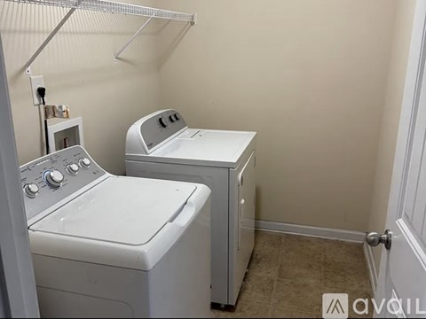 A small laundry room with a washer and dryer.