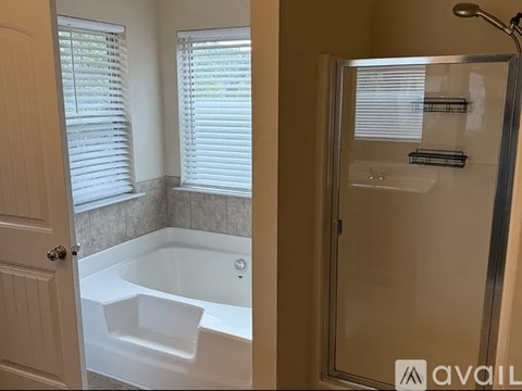 A bathroom with a white tub and a walk-in shower.