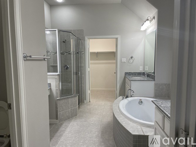A bathroom with a tub, sink, and shower.