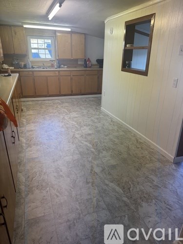A kitchen with a counter top and cabinets.